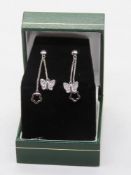 A pair of silver butterfly and floral drop earrings, stamped 925 with 925 silver butterfly backs,