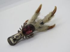A Scottish silver Grouse foot brooch having stag and purple stone upon, hallmarked for Glasgow 1950.