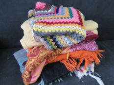A quantity of assorted throws including two crochet examples.