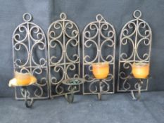 Four contemporary cast metal wall candle sconces.