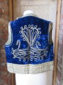 An antique blue velvet waistcoat.