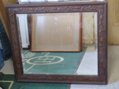 A delightful Art Nouveau framed rectangular mirror having good bevel edged glass and lily type