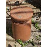 A terracotta chimney pot and top.