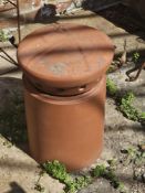 A terracotta chimney pot and top.