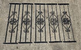 A set of five black painted metal balustrades or decorative panels, each 91.5cm tall.