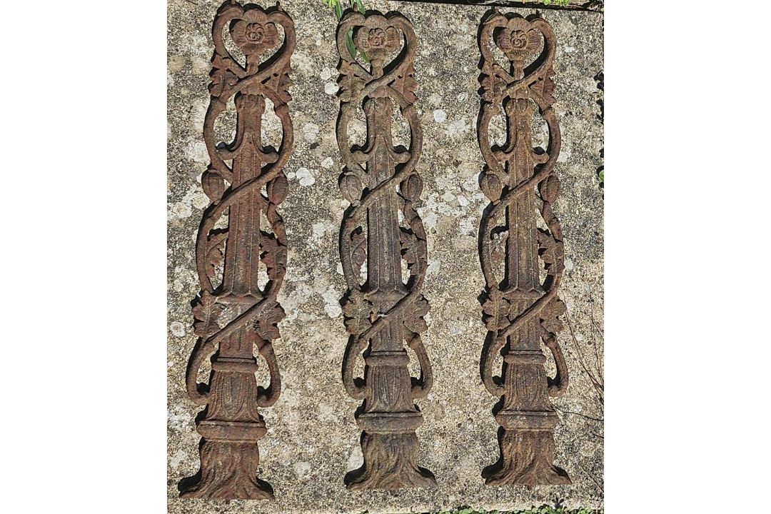 A set of three cast iron balustrades or decorative panels.
