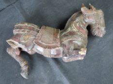 An Asian carved and painted wooden figure of a horse, a/f, approx 40cm in length.