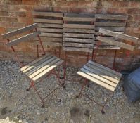 A set of six wood and metal bistro chairs.