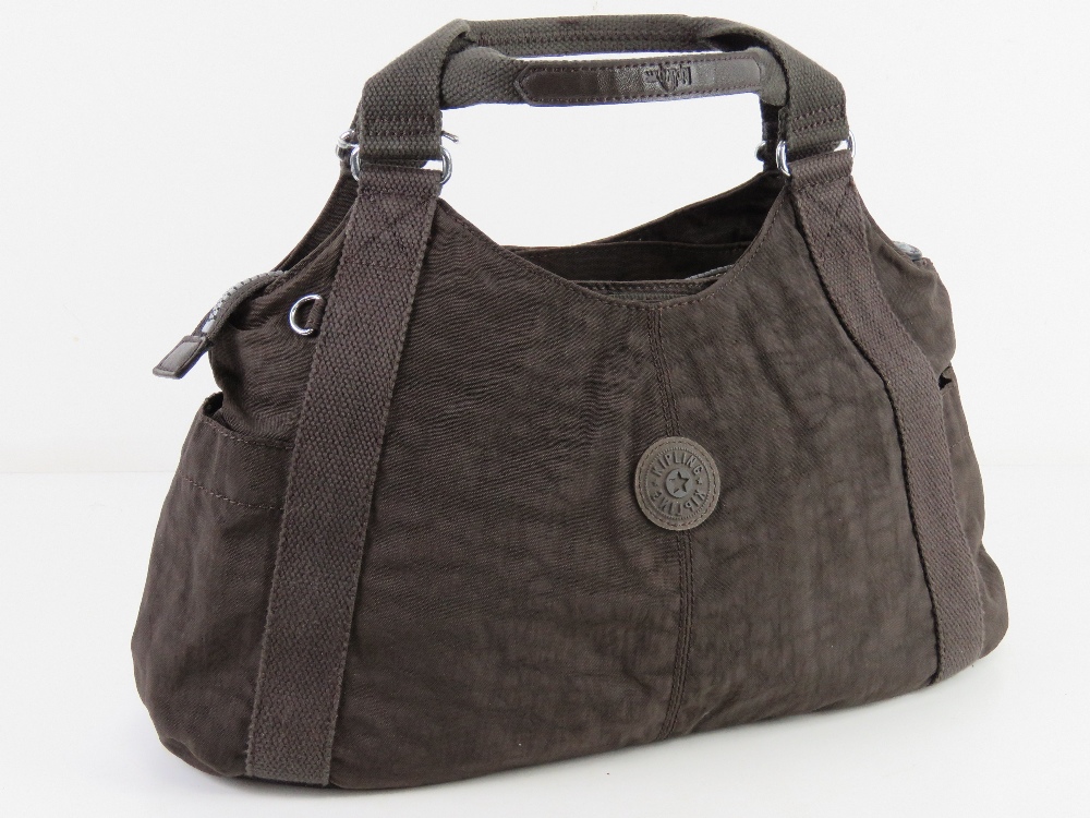 A brown canvas handbag by Kipling approx 45cm wide.