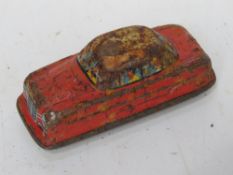 A tin-plate clockwork toy car.