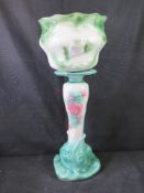 A ceramic planter on stand.