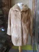 A ladies vintage fur coat.