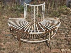 A white painted metal half tree bench.