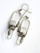 A pair of white crystal snake themed earrings.