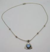 A silver Native American Navajo style necklace and opal pendant.