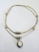 A silver bead necklace and opal pendant in the Native American style, stamped 925.