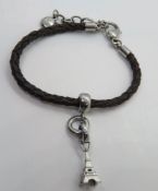 A leather bracelet by Fossil having Eiffel Tower Paris charm upon.