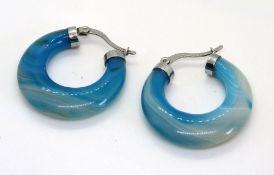 A pair of blue agate hoop earrings.