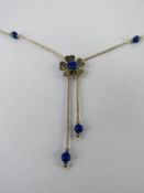 A Native American style silver beaded necklace having blue stone set floral design, marked Sterling.