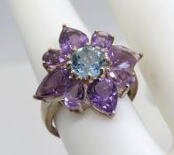 A purple and blue stone floral cluster ring, stamped 925.