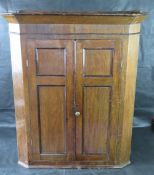 An antique oak hanging corner cabinet.