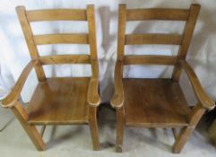 A pair of substantial wide frame oak dining chairs