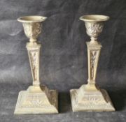 A pair of silver plated candlesticks, plating worn.