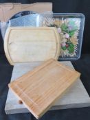 A quantity of assorted chopping boards and platters.