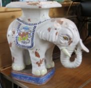 A large terracotta enamel painted elephant plant pot stand.