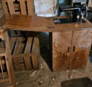 A vintage Singer sewing machine in cabinet.