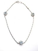 An aquamarine and diamond floral pattern anklet, no apparent hallmarks, approx 25cm in length, 8.5g.