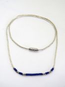 A silver and blue bead necklace in the Native American style.