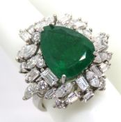 An impressive emerald and diamond cocktail ring featuring central pear cut emerald measuring approx
