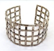 A wide silver latticework bangle, stamped 925.