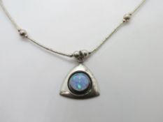 A silver Native American Navajo style necklace and opal pendant.