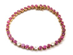A diamond and pink sapphire tennis bracelet, the three round cut brilliant diamonds approx 4.