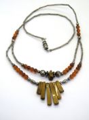 A carnelian bead, silver bead and tigers eye panel necklace in the Native American style.