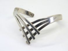 A substantial silver bangle, stamped 925.