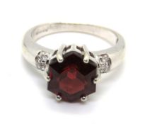 A 9ct white gold ring having central hexagonal cut red stone, hallmarked, 4.5g, size N-O.