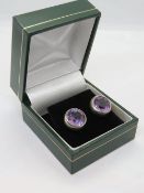 A pair of silver purple stone earrings in presentation box.