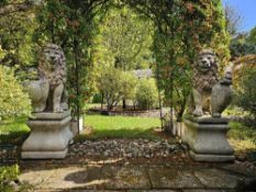 A fine and impressive large pair of cast stone heraldic lions, each standing 132cm high.