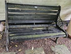 A slatted garden bench with cast iron ends, 126cm wide.
