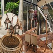Three copper coloured Indo-Asian hanging lanterns comprising large lamp on stand 202 high,