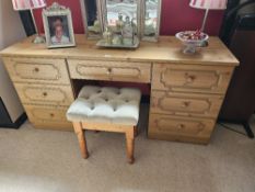 A contemporary pine effect dressing table comprising central drawer flanked by drawer to each