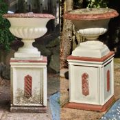 A pair of cast concrete classical garden urns raised over square shaped bases, 54cm dia, 94cm high.