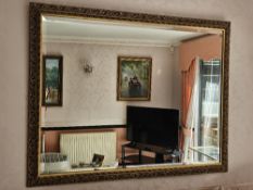A contemporary decorative pierced and gilded bevelled edge wall mirror, 130 x 100cm.