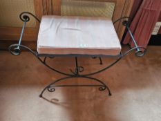A wrought iron calimnos stool with single cushion, 92cm wide.