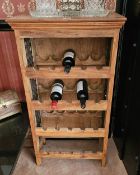 A contemporary wooden four tier open fronted wine rack, 104cm high.
