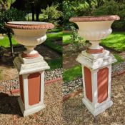 A pair of cast concrete classical garden urns raised over square shaped bases, 54cm dia,