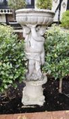 A cast concrete birdbath, 127cm high, 50cm wide.